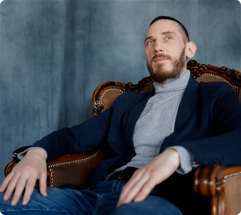 Andrew, laser tattoo removal specialist, sitting in a leather armchair